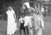 Gandhi walking with Kasturba and grandson