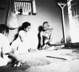 Gandhi and Sushila Nayar sitting in his hut