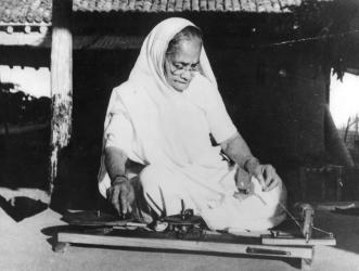Kasturba Gandhi at the spinning wheel